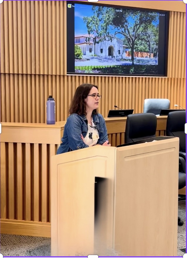 A judge speaking at the podium during the ceremony